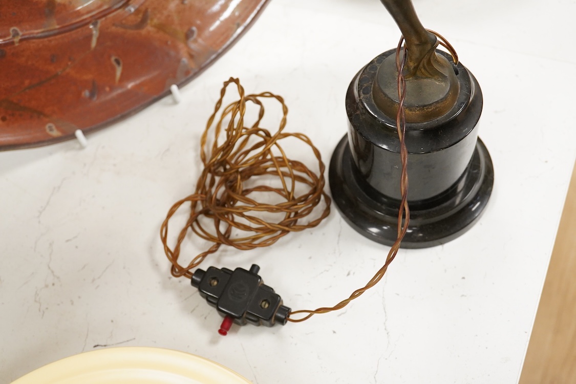 An Art Deco spelter ‘Dancing Girl’ table lamp with a frosted glass globe shade, 57cm high